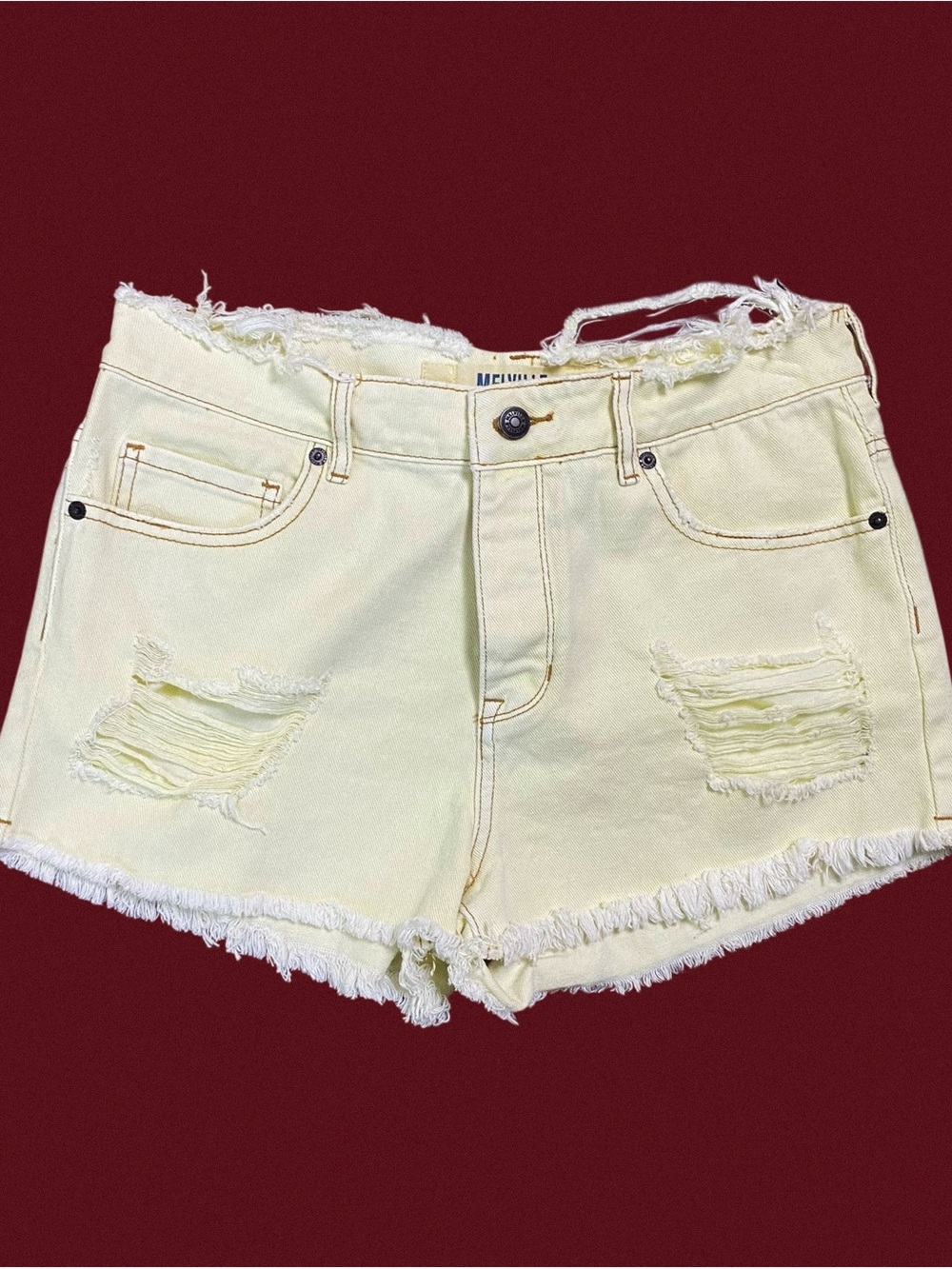 Yellow denim shorts with frayed hem